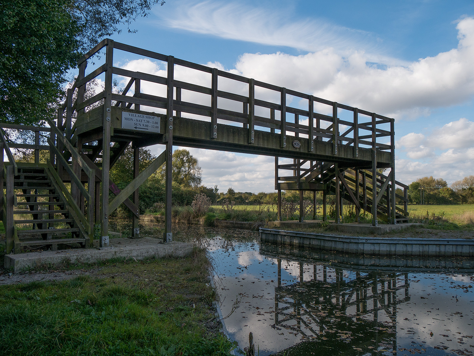 New wooden bridge and a reminder that there is a village nearby.